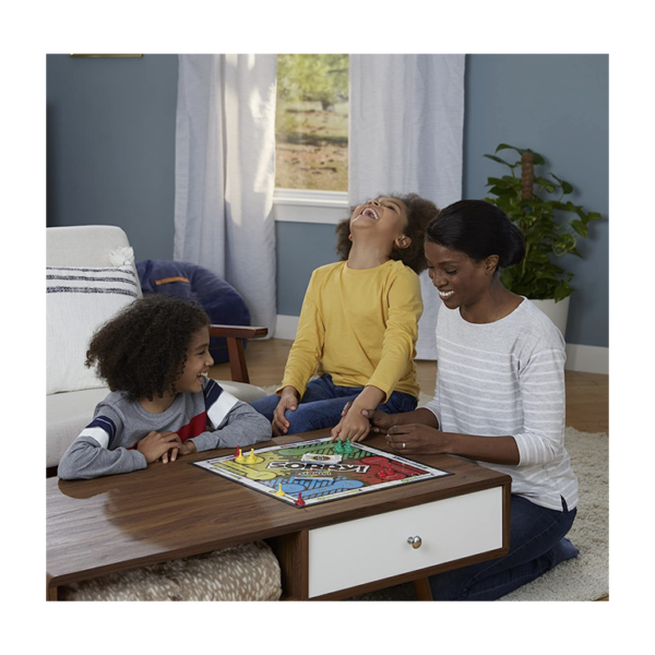 A mother and two daughters playing the Sorry board game